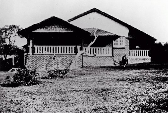 "Wyewurk", Thirroul, with Lawrence writing in the garden facing the sea